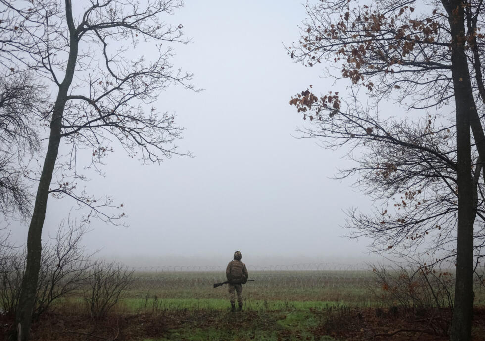 A serviceman of the 93rd Kholodnyi Yar Separate Mechanized Brigade of the Ukrainian Armed Forces checks the sky as he looks out for Russian combat drones near the frontline town of Kostiantynivka.