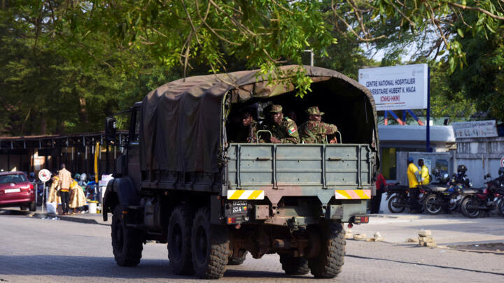 Soldiers patrol in a military vehicle in Cotonou, Benin, after the country's armed forces thwarted an attempted coup against the government.