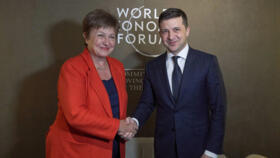 Ukrainian President Volodymyr Zelenskiy, right, shakes hands with International Monetary Fund (IMF) Managing Director Kristalina Georgieva during the 50th annual meeting of the World Economic Forum.