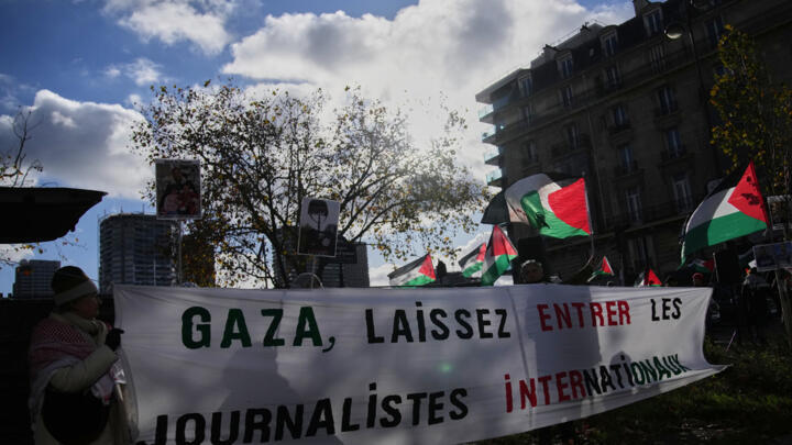 Demonstrators hold a banner reading 'Gaza, let the internationals journalists enter' during a protest in Paris, France, Thursday, Nov. 20, 2025.