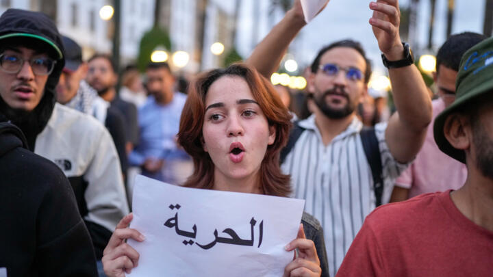 People take part in a youth-led protest against corruption and calling for education and healthcare reforms, in Rabat, Morocco, on October 9, 2025. Banner in Arabic reads "Freedom". 