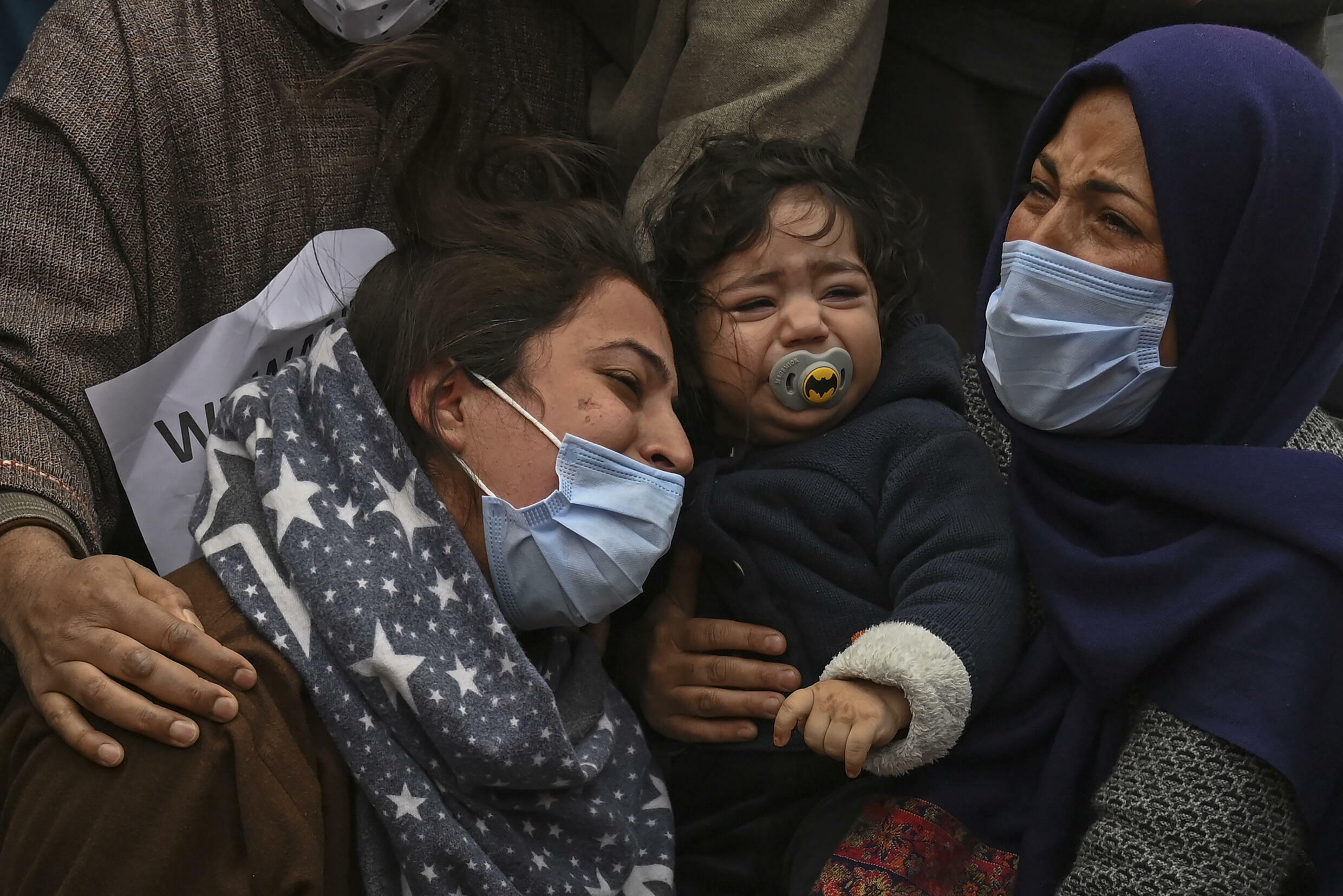 Humaira Mudasir (left), whose husband was killed in the operation, in the crowd with her daughter (centre)