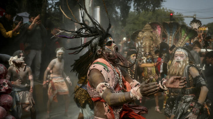 Hindu worshippers smeared with ashes dance during a religious procession before the Kumbh Mela festival in Prayagraj, India, January 10, 2025.