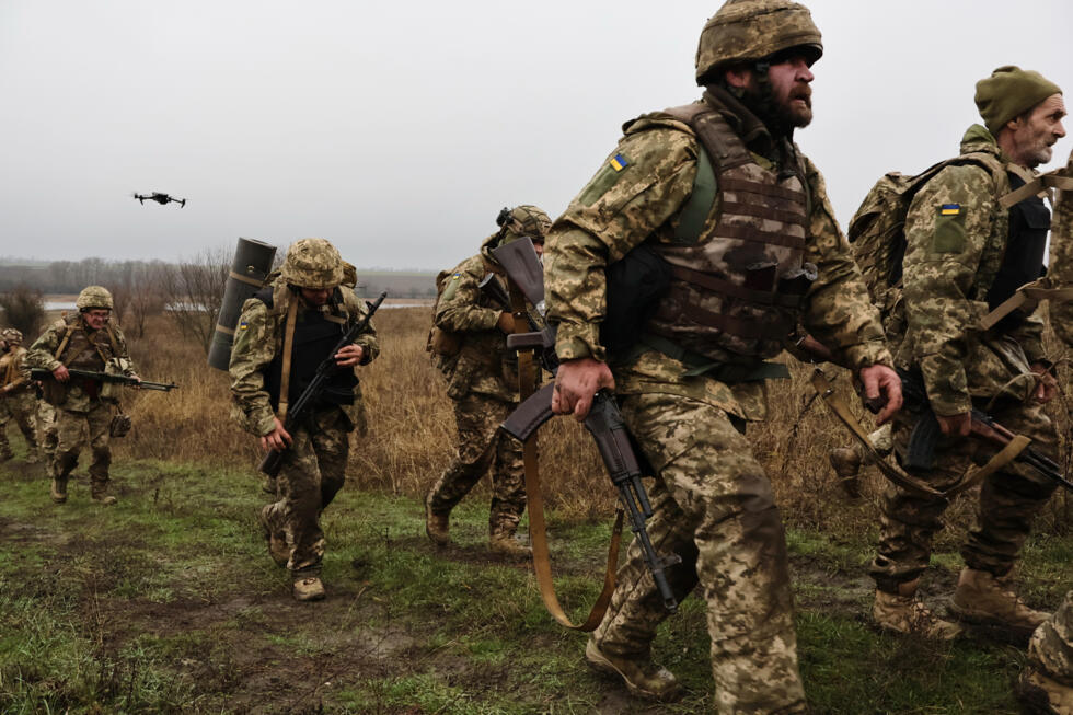 In this handout photograph taken and released by the press service of the 65th Mechanized Brigade of Ukrainian Armed Forces on December 12, 2025, Ukrainian recruits complete basic military training at