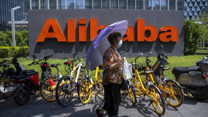 A woman stands outside the Alibaba offices in Beijing