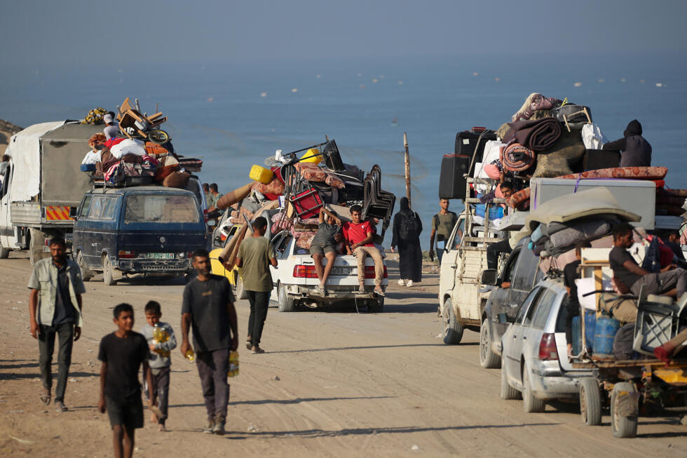 Displaced Palestinians move with their belongings southwards following renewed Israeli attacks on Gaza City.