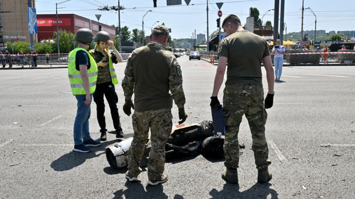 Police experts examine fragments of a missile after Russia fired a barrage of missiles for the second time in 24 hours, in an unusual daytime attack targetting the Ukrainian capital following overnight strikes, in Kyiv, on May 29, 2023. 