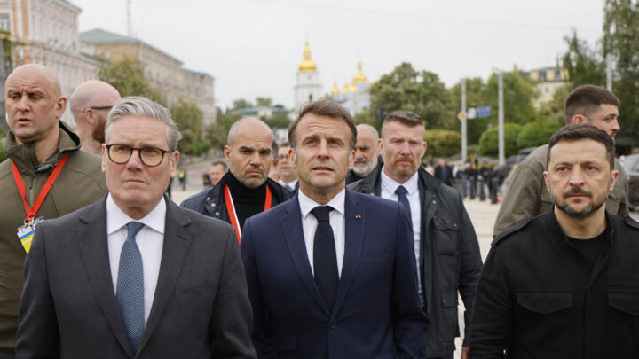 (From L) Britain's Prime Minister Keir Starmer, France's President Emmanuel Macron and Ukraine's President Volodymyr Zelensky take a walk after visiting Saint Sophie Cathedral, in Kyiv on May 10, 2025