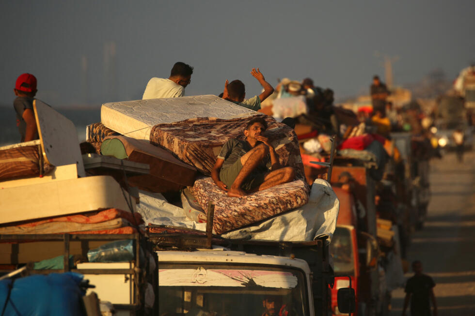 Displaced Palestinians move south with their belongings on a road in the Nuseirat refugee camp area in the central Gaza Strip on September 24, 2025.
