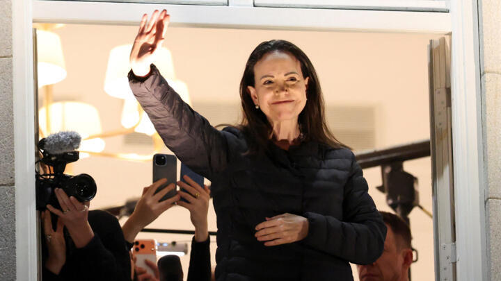 Nobel Peace Prize laureate Maria Corina Machado waves from a balcony of Grand Hotel, after her daughter Ana Corina Sosa Machado, accepted the award on her behalf, in Oslo, Norway December 11, 2025.