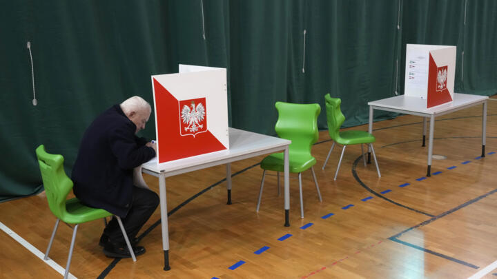 A man prepares to cast his ballot during parliamentary elections in Warsaw, Poland on Octeber 15, 2023.