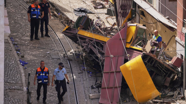 Police officers inspect the site where a funicular train popular with tourists derailed and crashed in Lisbon, on September 4, 2025.