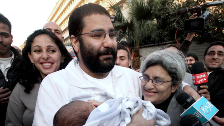 File photo taken December 25, 2011 of Alaa Abdel-Fattah with his newborn son, his mother Laila Soueif (right), and his wife Manal Bahey, after his release, in Cairo, Egypt.