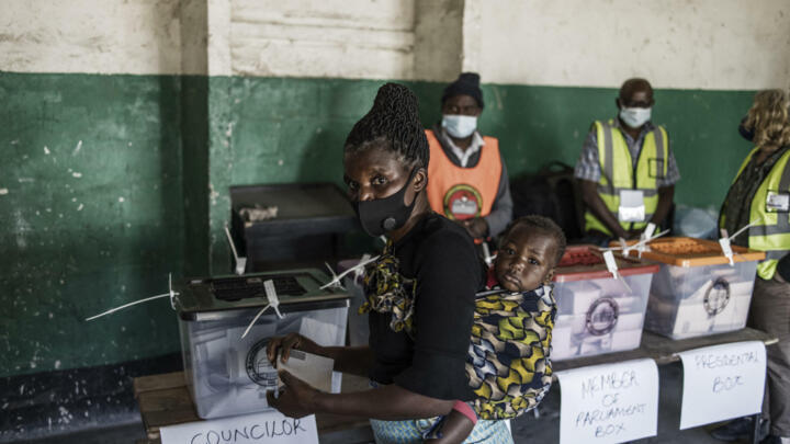 A woman proceeds to cast her ballots at a polling station in Lusaka on August 12, 2021, as Zambians elect their next president after a tense campaign dominated by economic woes in Africa's first coronavirus-era sovereign defaulting country.