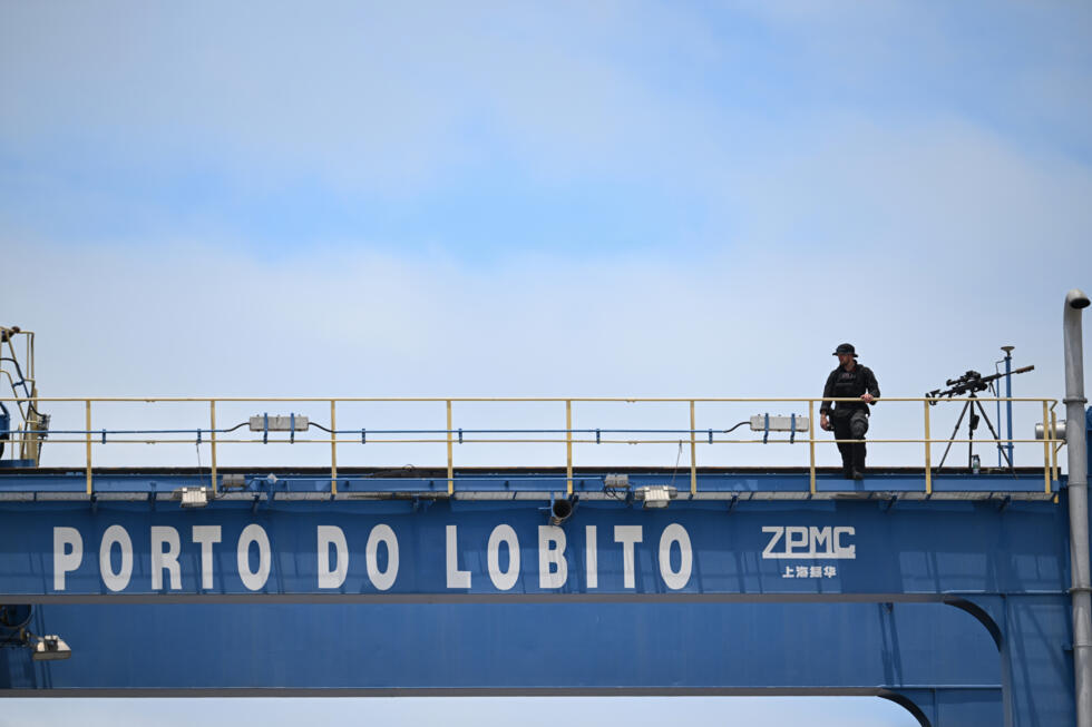 A man stands on a piece of infrastructure in the Lobito corridor.