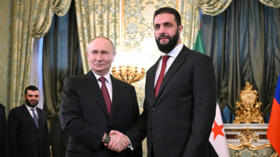 Russia's President Vladimir Putin shakes hands with Syria's Ahmed al-Sharaa in Moscow on October 15, 2025.