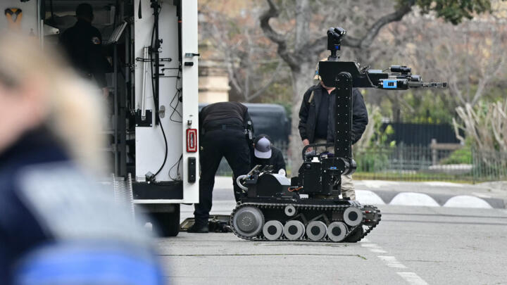 Bomb-squad officers prepare a demining robot in front of the Russian consulate in Marseille, after three improvised explosive devices were thrown, on February 24, 2025. No one was injured.