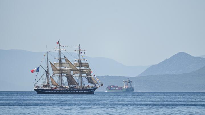 The Olympic flame is being brought to France from Greece on a 19th-century tall ship
